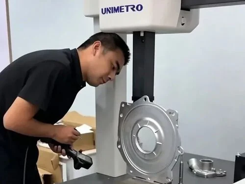 Quality control engineer operating CMM inspection equipment