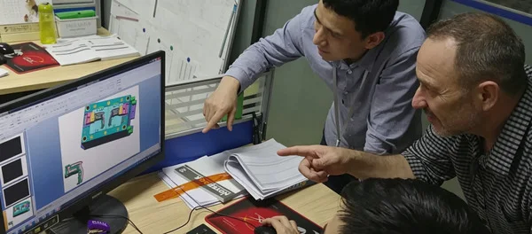 YCS engineering team reviewing a CNC machining drawing
