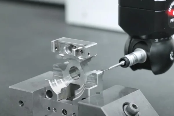 YCS quality team inspecting a CNC machined component